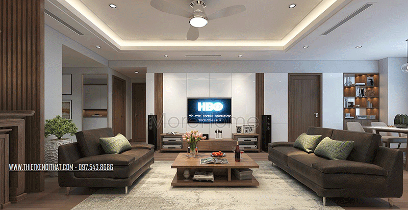 Nổi bật giữa phòng khách là bộ sofa bằng nỉ màu socola và chiếc bàn trà bằng gỗ với thiết kế độc đáo là điểm nhấn cho phòng khách chung cư